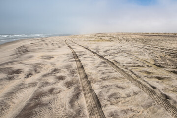 Car tire tracks in the sand of Skeleton Coast, Namibia - 756714493