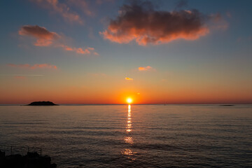Watching dramatic sunset at coastal village Funtana, Istria, Croatia, EU. Silhouette of remote...