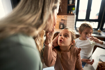  Messy and happy: Laughter fills the air as girls and family share joyful moments at the breakfast table, enjoying the sweet chaos of spreading jam.