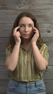 Person practicing EFT. Female tapping side of the eye (SE) meridian point. Vertical video.