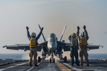 Deck crew signaling to F-16 for clear communication on aircraft carrier