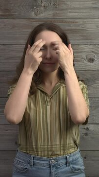 Person practicing EFT. Female tapping her eyebrow, inner eyebrow (EB) meridian point. Vertical video.