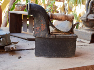 Antique black clothes iron on wood