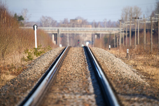 Train tracks with an overpass in the background