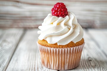 Tasty cupcake with butter cream and ripe raspberry on wooden table - obrazy, fototapety, plakaty