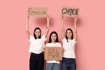 Portrait of beautiful women with different slogans on pink background