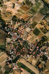 Aerial view of a small town surrounded by fields. Suitable for various marketing materials