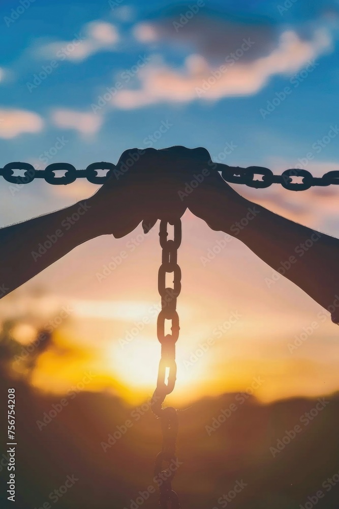 Poster a person holding a chain with the sun setting in the background. suitable for concepts of strength a