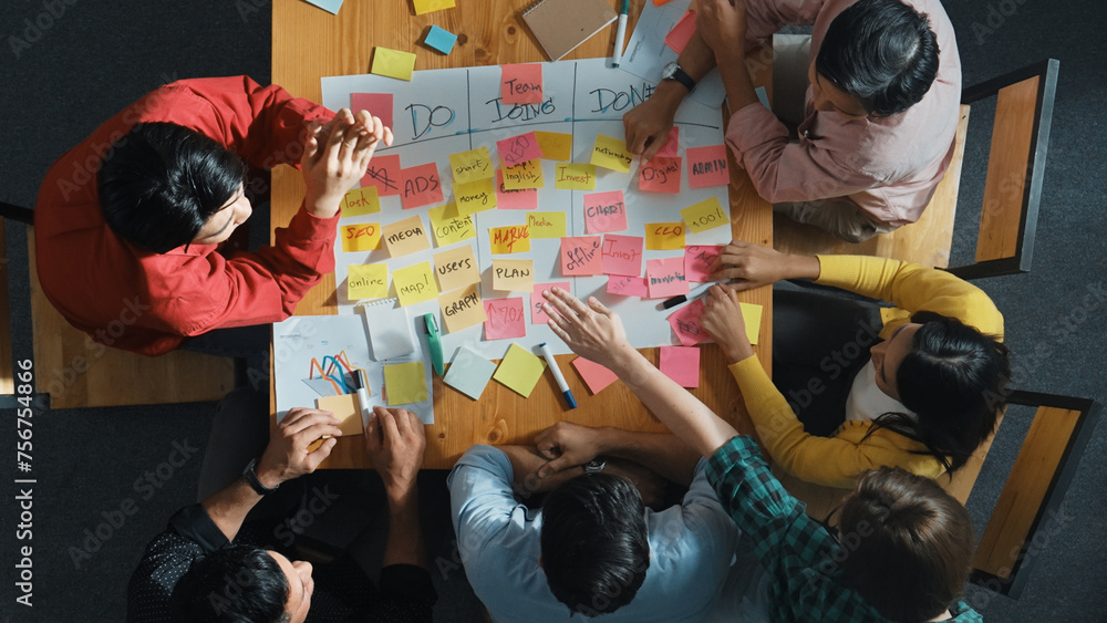 Poster top view of people writing and making scrum task board while writing marketing and planning strategy