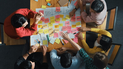 Top view of people writing and making scrum task board while writing marketing and planning...