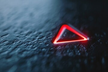 A striking red triangle on a dark black background. Suitable for graphic design projects