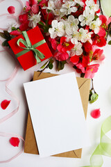 postcard mockup. spring flowers. flowering branches on a white background, envelope and white blank...