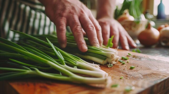 Person chopping green onions on a cutting board, suitable for cooking websites or culinary blogs