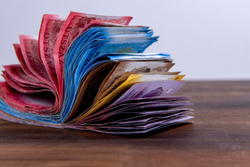 Hungarian HUF banknotes, pile of money on a brown wooden table