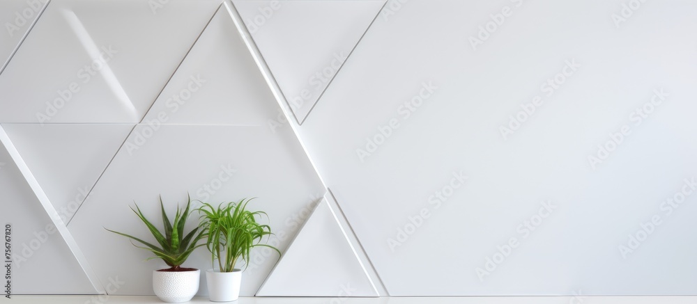 Poster two houseplants in flowerpots resting on a table against a white rectangular wall, adding a touch of