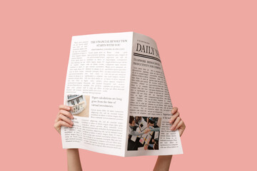 Woman with newspaper on pink background