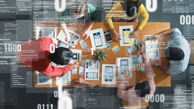 Top view of team brainstorming and looking tablet with coding program or engineering prompt. Group of marketing and creative people working together with programing system holographic. Convocation.