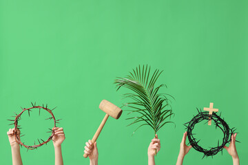 Female hands with crowns of thorns, mallet and palm leaf on green background. Good Friday concept