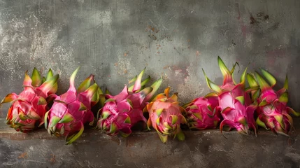 Foto op Canvas Exotic dragon fruit displayed on rustic background. Dragon fruit arrangement on textured surface for healthy diet. Fresh pitaya fruits on vintage grey backdrop for nutritious snack. © Irina.Pl