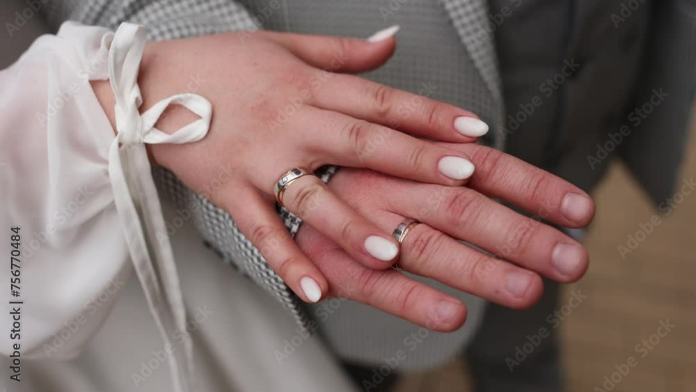 Poster a man holding a girl's hand with a wedding ring