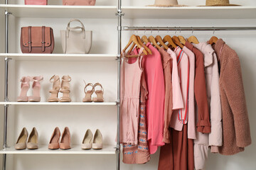 Rack with clothes and shoes in modern woman's wardrobe - obrazy, fototapety, plakaty