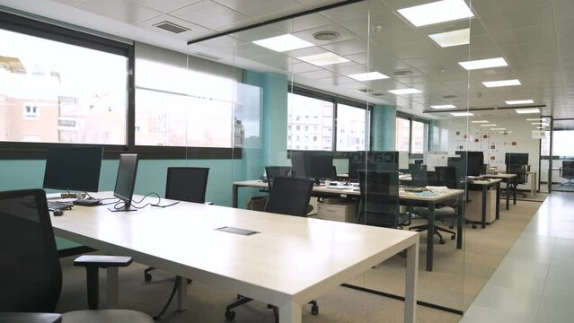 Interior of spacious office with computers on tables