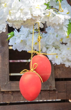 Red Easter eggs on a background of white flowers