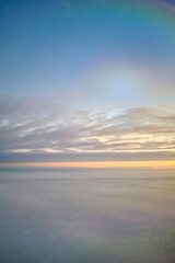 Beautiful sunset sky landscape cloudscape orange dusk seen from an airplane window high up in the...