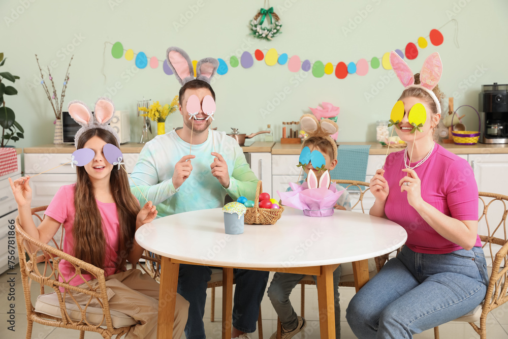 Canvas Prints Happy family with paper Easter eggs in kitchen