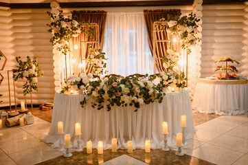 table in a restaurant decorated with flowers and candles.