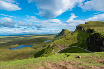 Fototapeta na wymiar Breathtaking view of hilly landscape dotted with blue lochs on the Isle of Skye