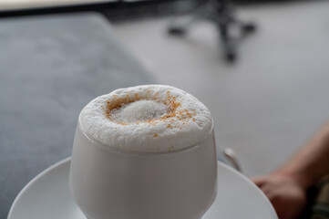 cappuccino with a large milk cap coffee milk drink with caffeine and sugar.