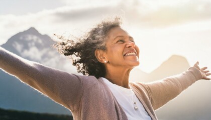  Calm happy smiling free elderly woman with closed eyes, arms spread out. Mature lady enjoying the outdoors and filled with joy and happiness.