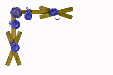 Painted yellow tan wood sticks are crossed into a fence design. Cowboy hats in purple are added and look as if they are hanging on the wood. Corner border has western hat theme.