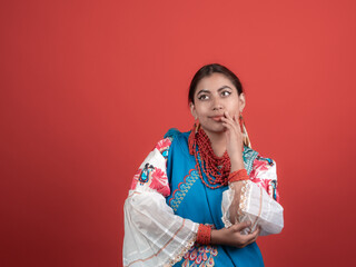 latin girl of kichwa origin looking incredulous with a red background