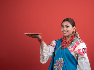 Hispanic girl of Kichwa origin with a red background and holding a plaque to place an object.