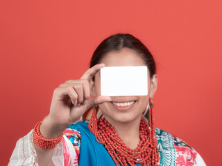 ecuadorian kichwa latina girl smiling showing a credit card hiding most of her face