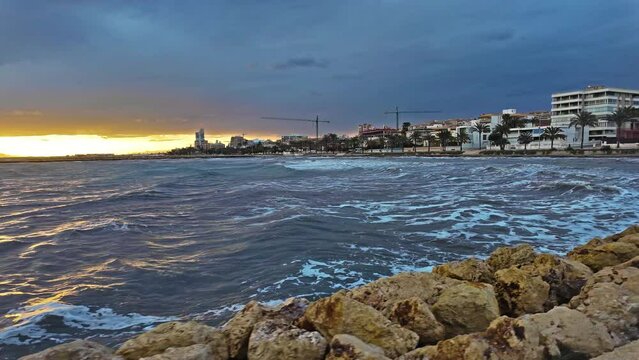 Beautiful big sea waves on the coast of a sea town