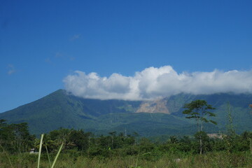 View of Mount Galunggung with its large gaping crater visible from Tasikmalaya city, West Java.