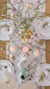 Spring Easter decor. Easter table setting. Flowers and dishes and candles for a festive dinner. High quality footage