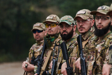 Soldier fighters standing together with guns. Group portrait of US army elite members, private...