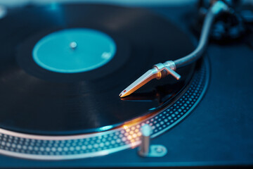Close-up of a turntable needle on a vinyl record, depicting vintage audio.
