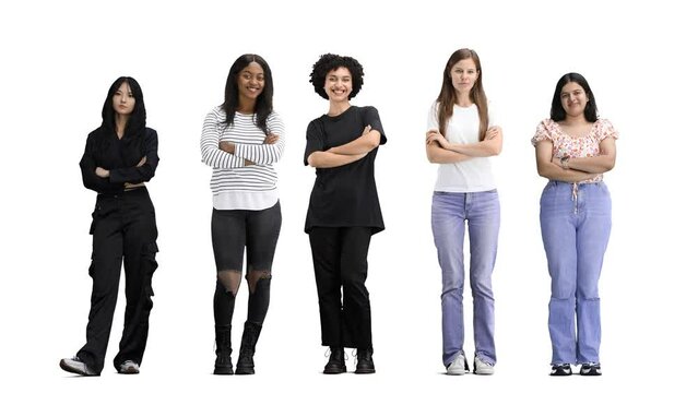 A group of people, on a white background, in full height, crossed their arms