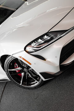 White Toyota Supra MK.5 headlight and wheel focused shot, tilted - High Resolution Image