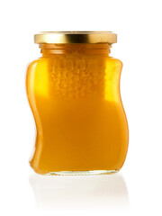 Glass bottle of fine honey with golden lid on white background. Agriculture organic product famous for its sweet taste and health benefits and value.