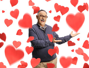 Cheerful mature man in love pointing at red hearts