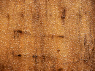 Snow flakes on orange color metal texture. Abstract background for design.