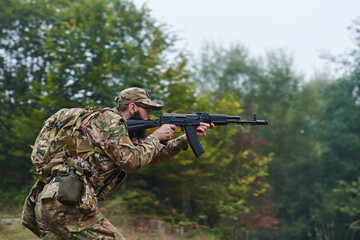 An elite soldier, camouflaged and stealthily navigating through dangerous woodland terrain,...
