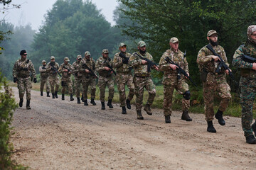 An elite military unit, led by a major, confidently parades through dense forest, showcasing...