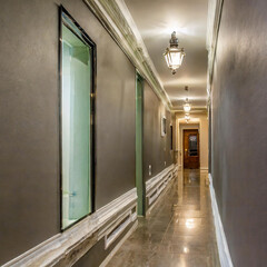 The interior design of a contemporary home hallway corridor at night features a wall with moulding.